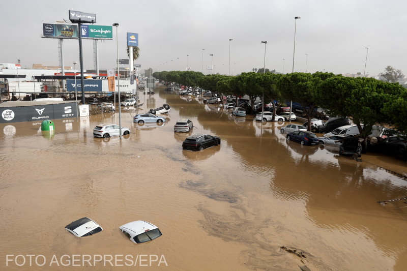 Damaged vehicles lie amidst flood waters at an industrial complex in Sedavi, in the province of Valencia, eastern Spain, 30 October 2024.